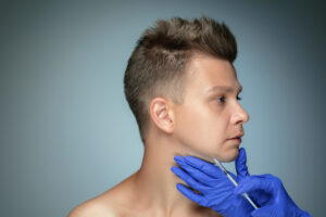 Close Up Portrait Of Young Man Isolated On Grey Studio Background