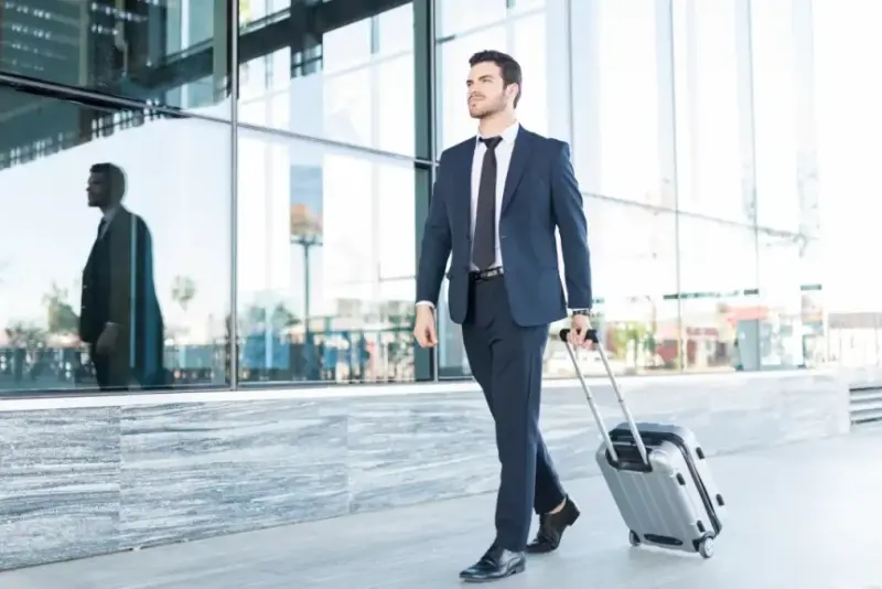 Full Length Handsome Young Man Suit Walking With Luggage Outside Office Building 1024x576