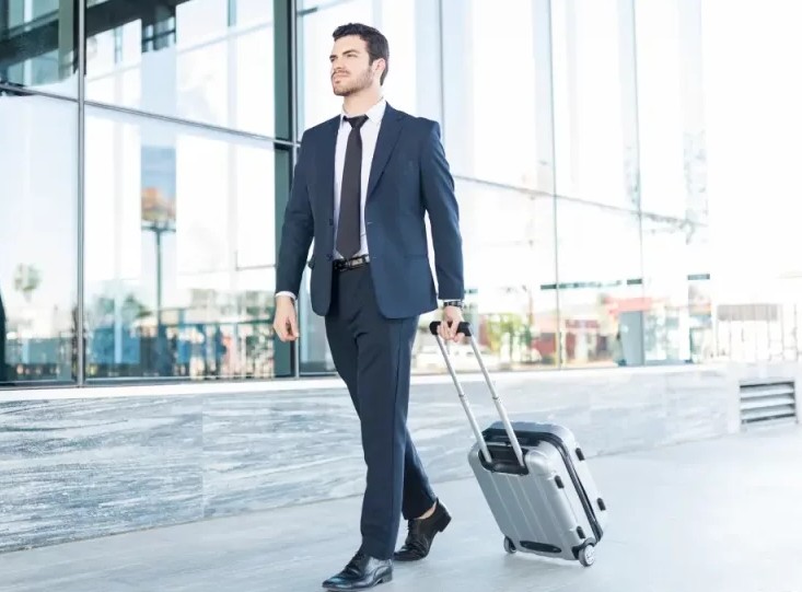 Full Length Handsome Young Man Suit Walking With Luggage Outside Office Building 1024x576