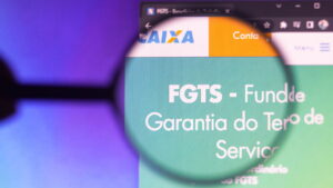 May 27, 2022, Brazil. In This Photo Illustration, The Homepage Of The Fundo De Garantia Do Tempo De Serviço (fgts) Website Seen On A Computer Screen Through A Magnifying Glass.